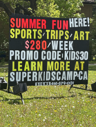 Outdoor Summer Program Advertisement on a Large Vertical and Horizontal Signboard in a Green Open Space in Toronto